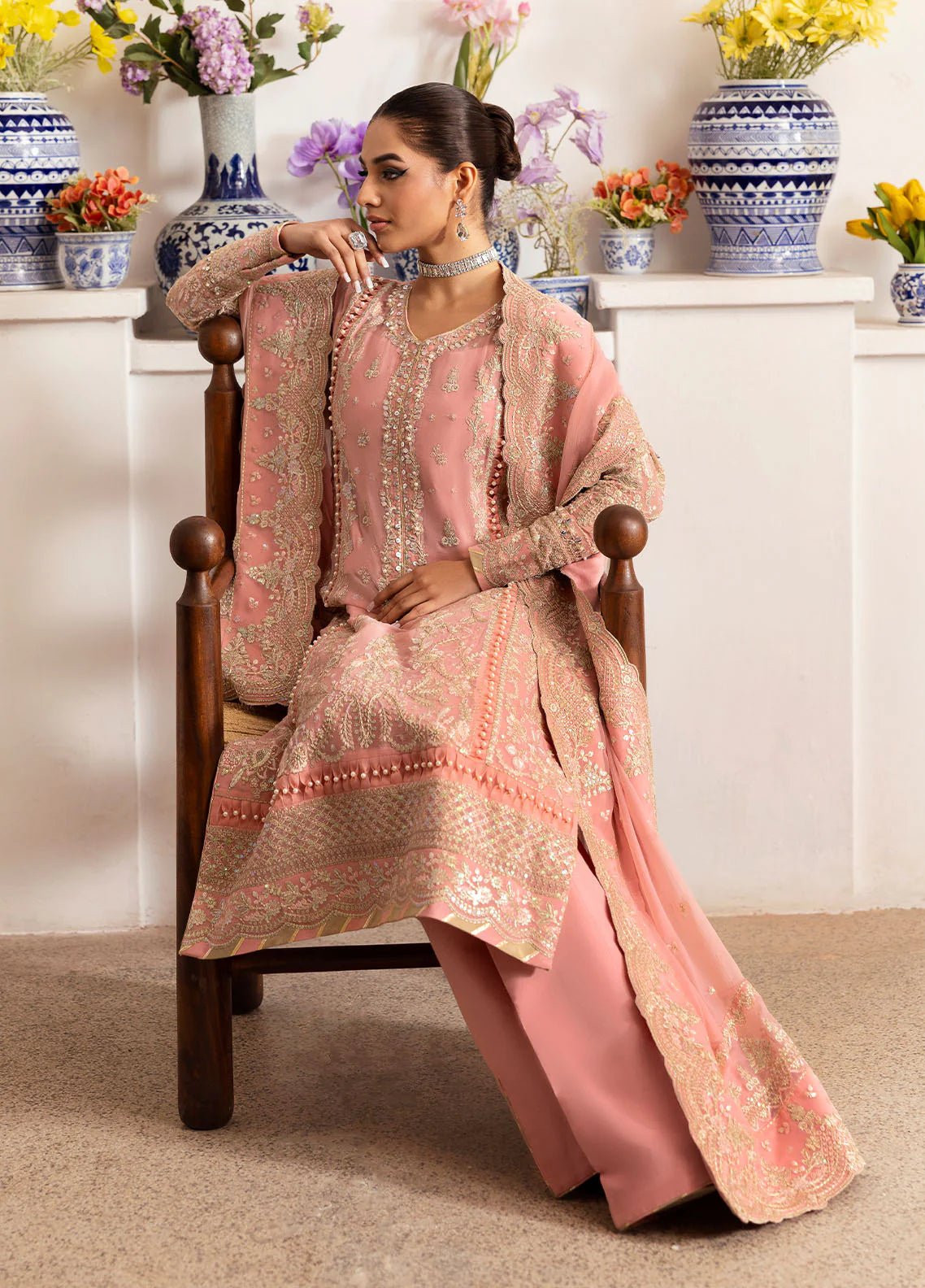 Model wearing Gulaal Coralyn blush pink embroidered chiffon dress with embellished dupatta. Shop Pakistani clothes online in the UK now.