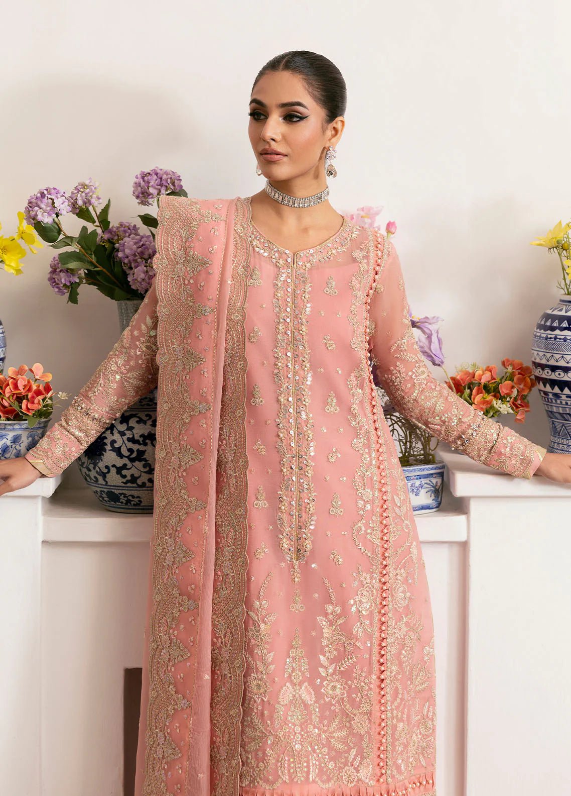 Model wearing Gulaal Coralyn blush pink embroidered chiffon dress with embellished dupatta. Shop Pakistani clothes online in the UK now.