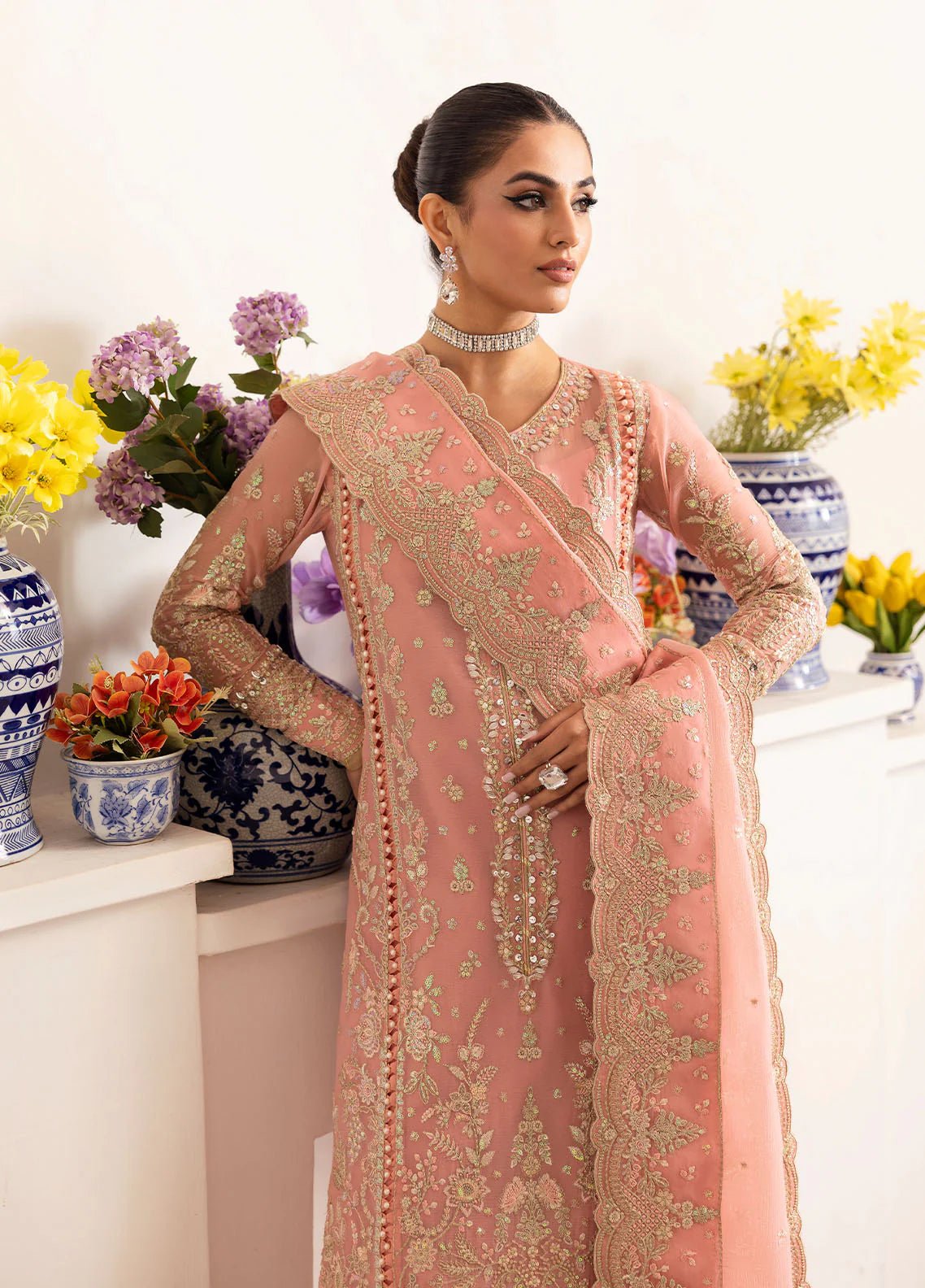 Model wearing Gulaal Coralyn blush pink embroidered chiffon dress with embellished dupatta. Shop Pakistani clothes online in the UK now.