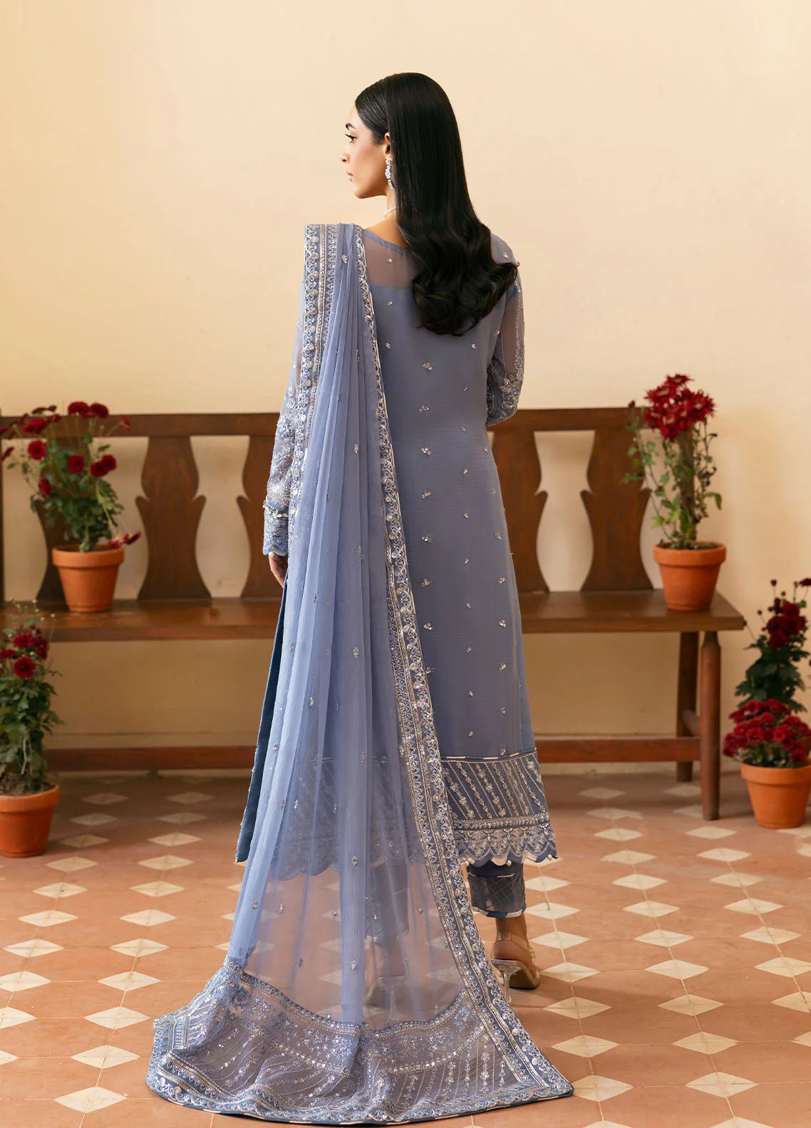 Model wearing Gulaal Meher periwinkle blue embroidered chiffon dress with intricate detailing and matching dupatta. Shop Pakistani clothes online in the UK now.