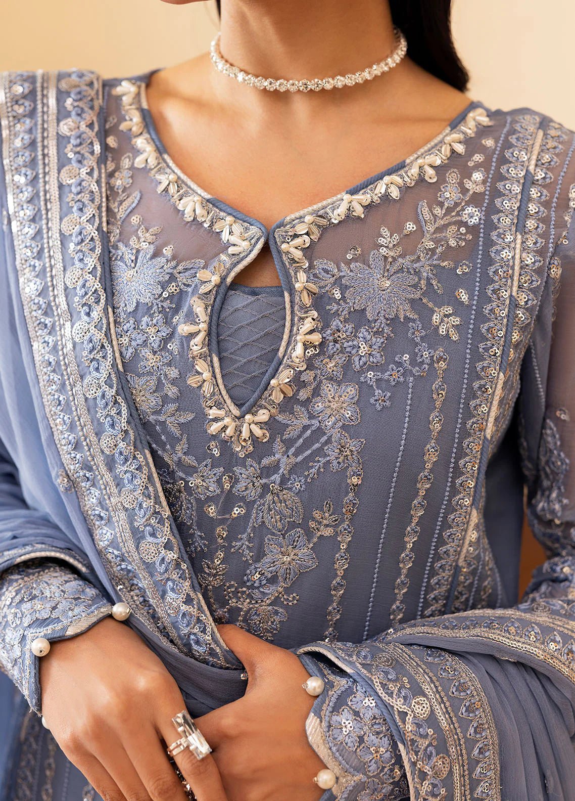 Model wearing Gulaal Meher periwinkle blue embroidered chiffon dress with intricate detailing and matching dupatta. Shop Pakistani clothes online in the UK now.