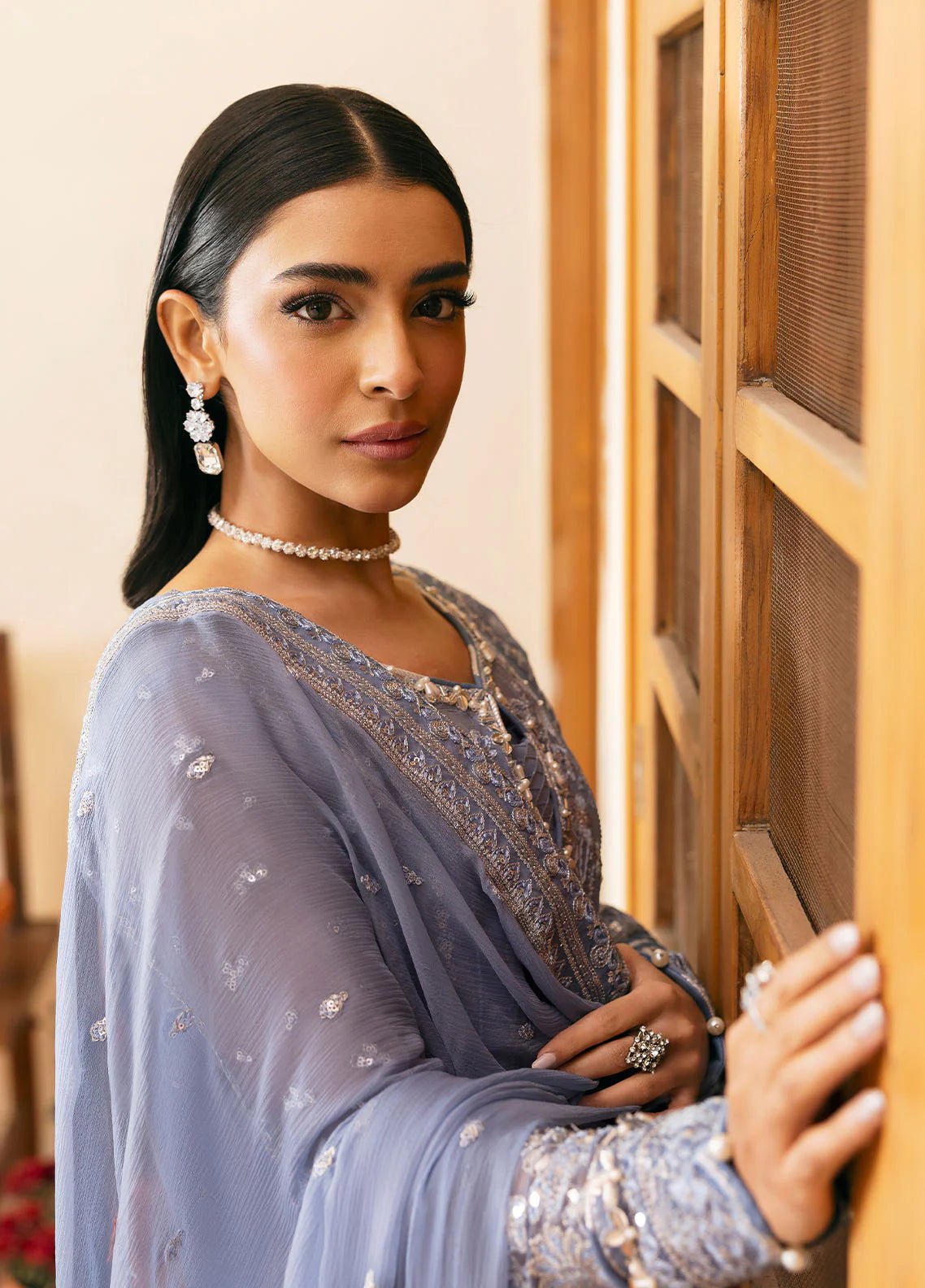 Model wearing Gulaal Meher periwinkle blue embroidered chiffon dress with intricate detailing and matching dupatta. Shop Pakistani clothes online in the UK now.