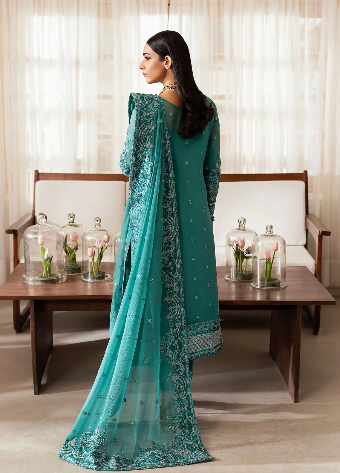 Model wearing Gulaal Miral teal embroidered chiffon dress with matching dupatta and trousers. Shop Pakistani clothes online in the UK now.