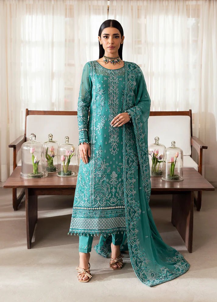 Model wearing Gulaal Miral teal embroidered chiffon dress with matching dupatta and trousers. Shop Pakistani clothes online in the UK now.