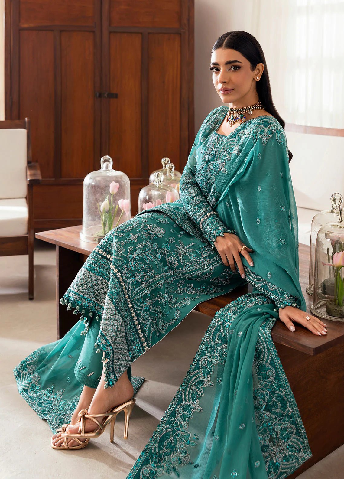 Model wearing Gulaal Miral teal embroidered chiffon dress with matching dupatta and trousers. Shop Pakistani clothes online in the UK now.