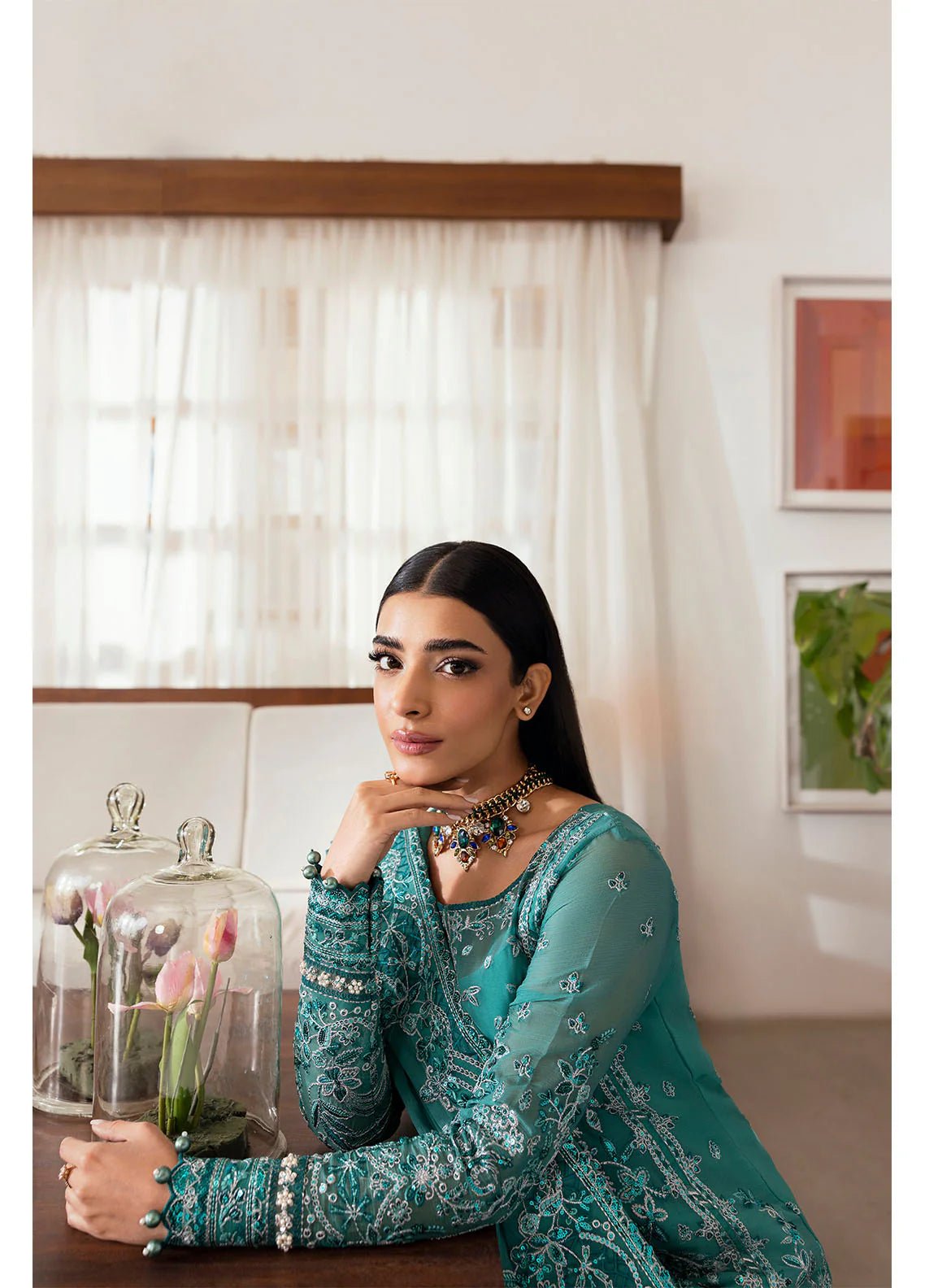 Model wearing Gulaal Miral teal embroidered chiffon dress with matching dupatta and trousers. Shop Pakistani clothes online in the UK now.