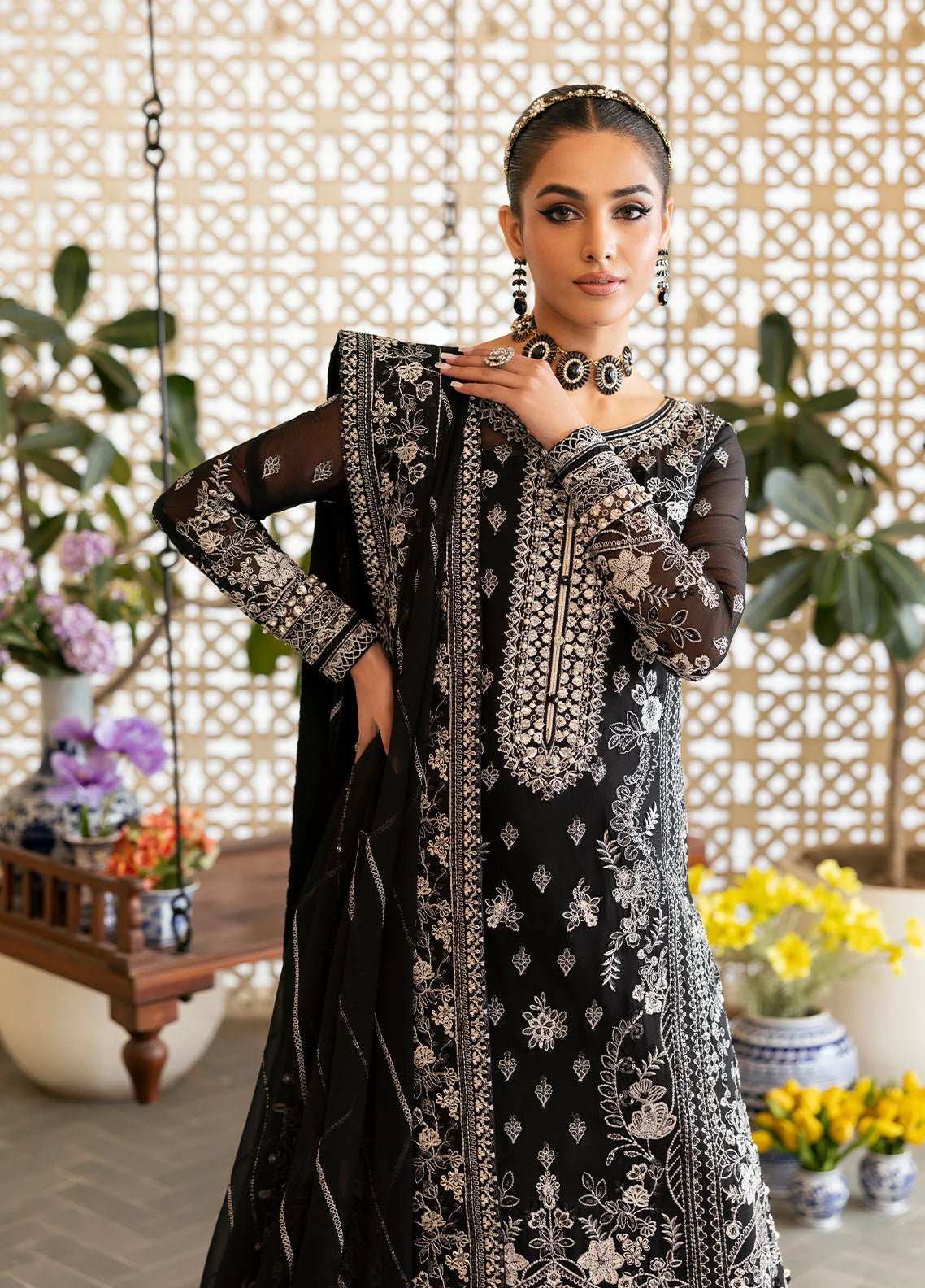 Model wearing Gulaal Nyra black embroidered chiffon dress with intricate silver detailing and dupatta. Shop Pakistani clothes online in the UK now.