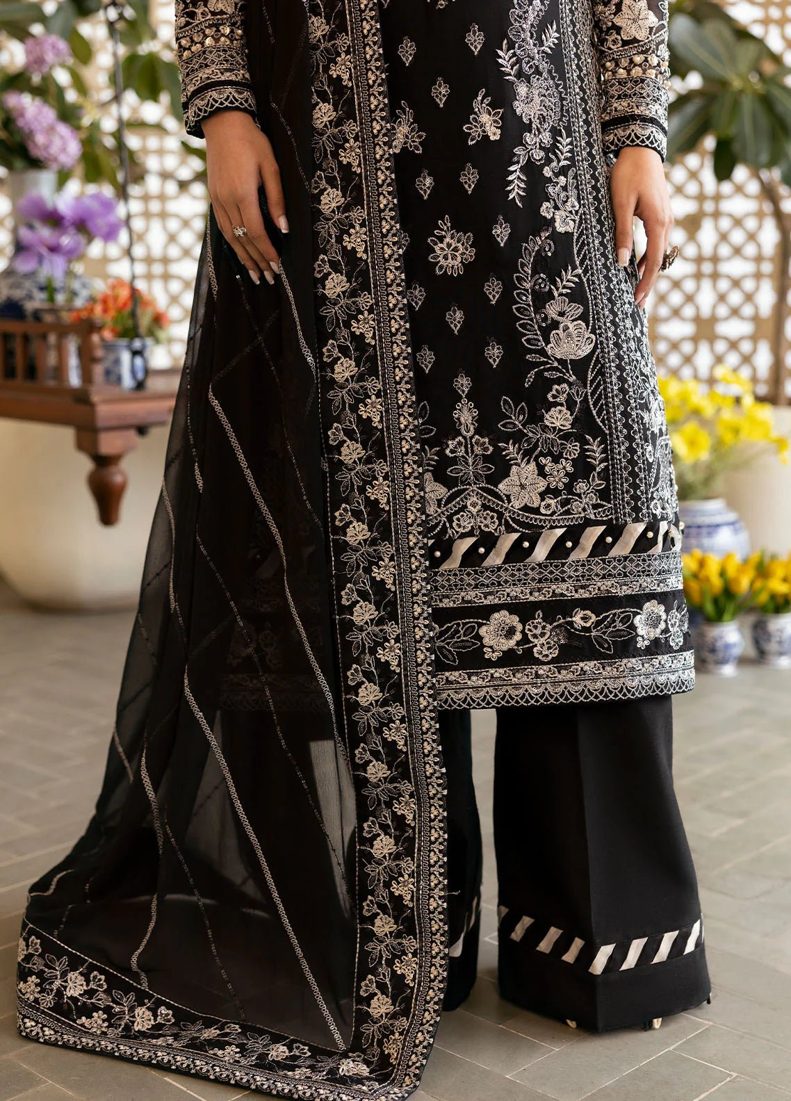 Model wearing Gulaal Nyra black embroidered chiffon dress with intricate silver detailing and dupatta. Shop Pakistani clothes online in the UK now.