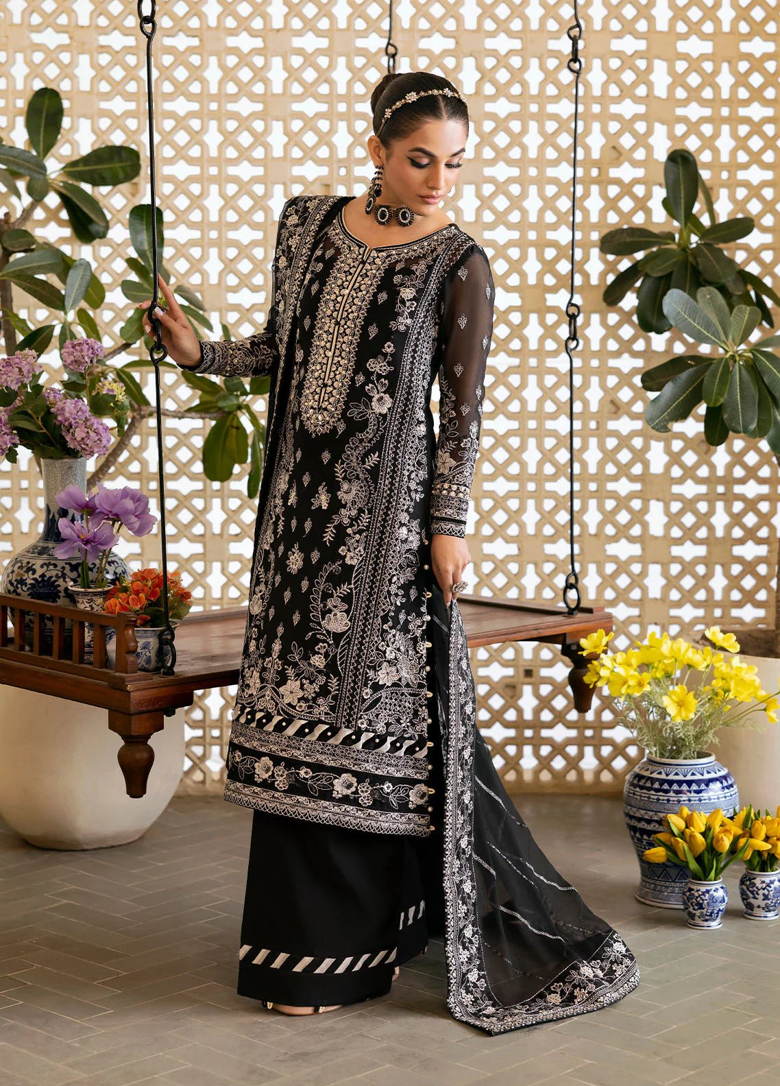 Model wearing Gulaal Nyra black embroidered chiffon dress with intricate silver detailing and dupatta. Shop Pakistani clothes online in the UK now.