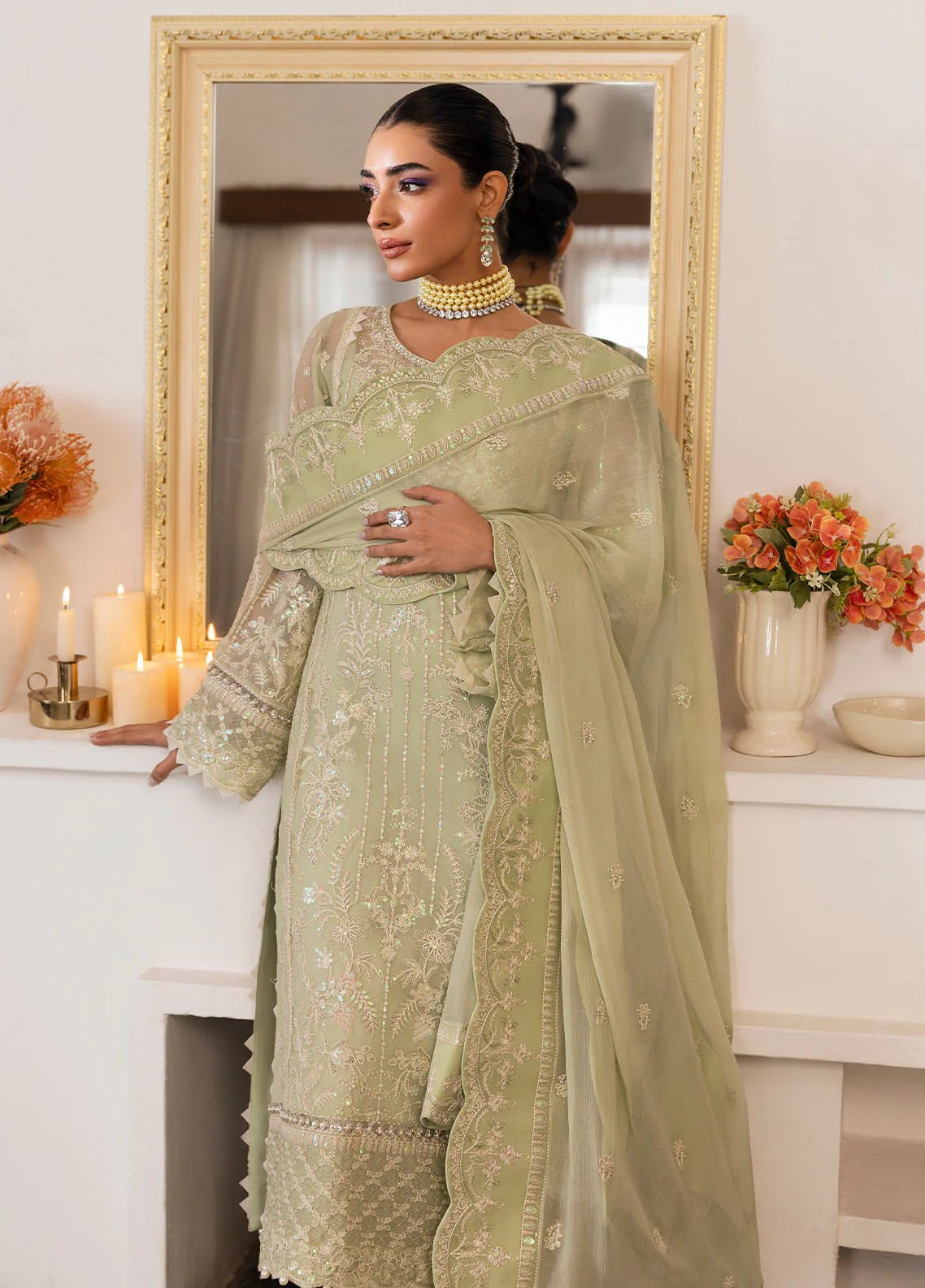 Model wearing Gulaal Virida pastel green embroidered chiffon dress with matching dupatta and trousers. Shop Pakistani clothes online in the UK now.