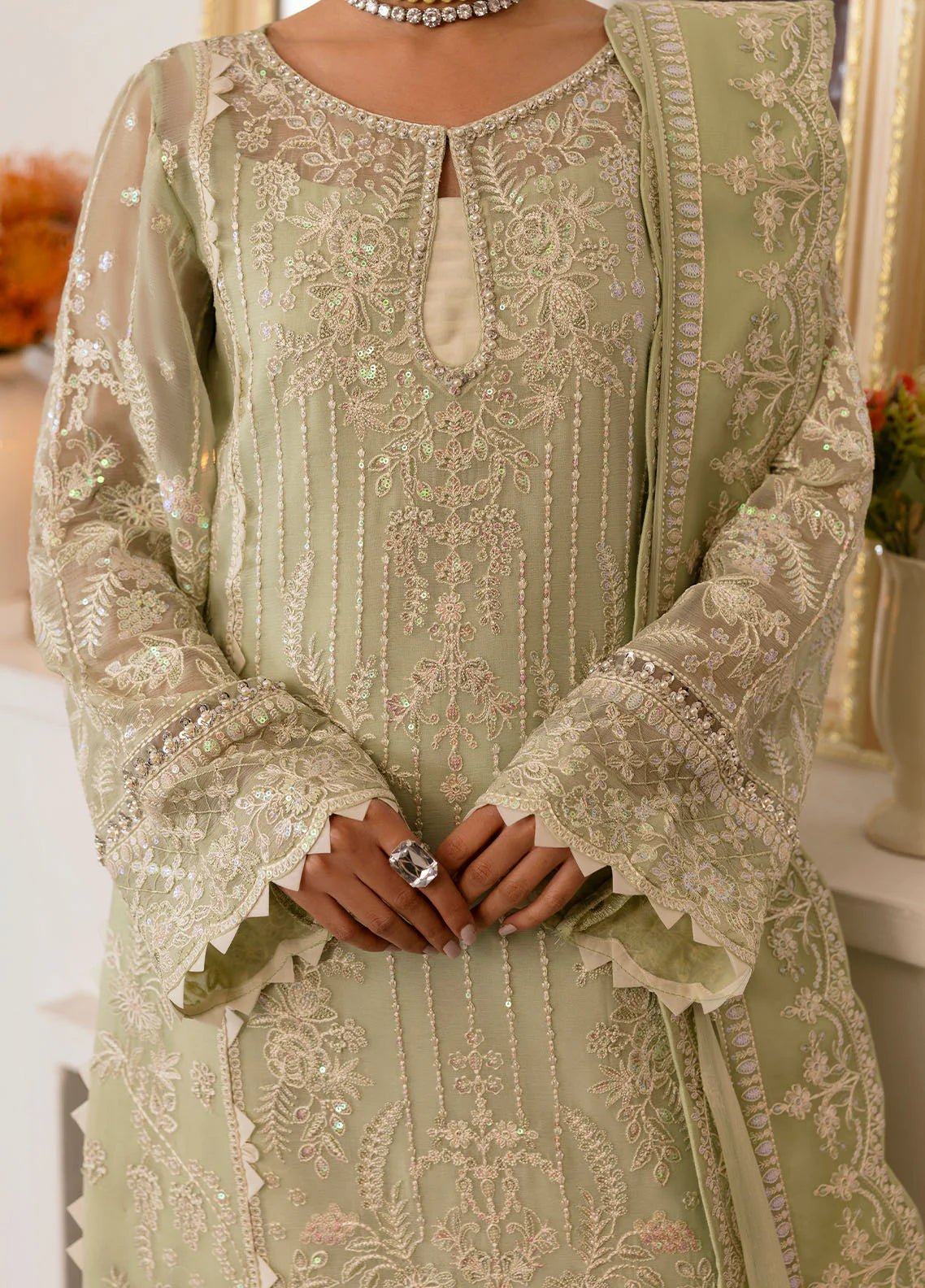 Model wearing Gulaal Virida pastel green embroidered chiffon dress with matching dupatta and trousers. Shop Pakistani clothes online in the UK now.