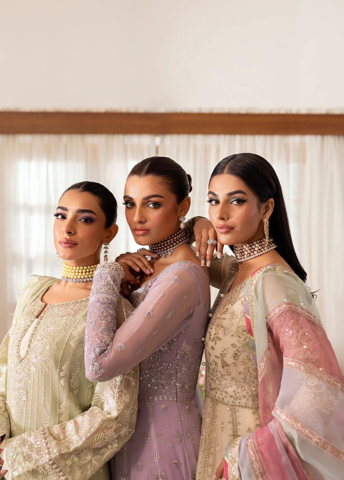 Model wearing Gulaal Virida pastel green embroidered chiffon dress with matching dupatta and trousers. Shop Pakistani clothes online in the UK now.