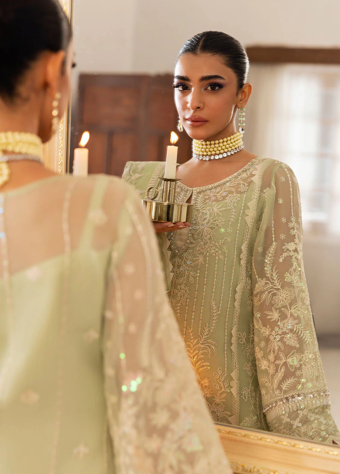 Model wearing Gulaal Virida pastel green embroidered chiffon dress with matching dupatta and trousers. Shop Pakistani clothes online in the UK now.