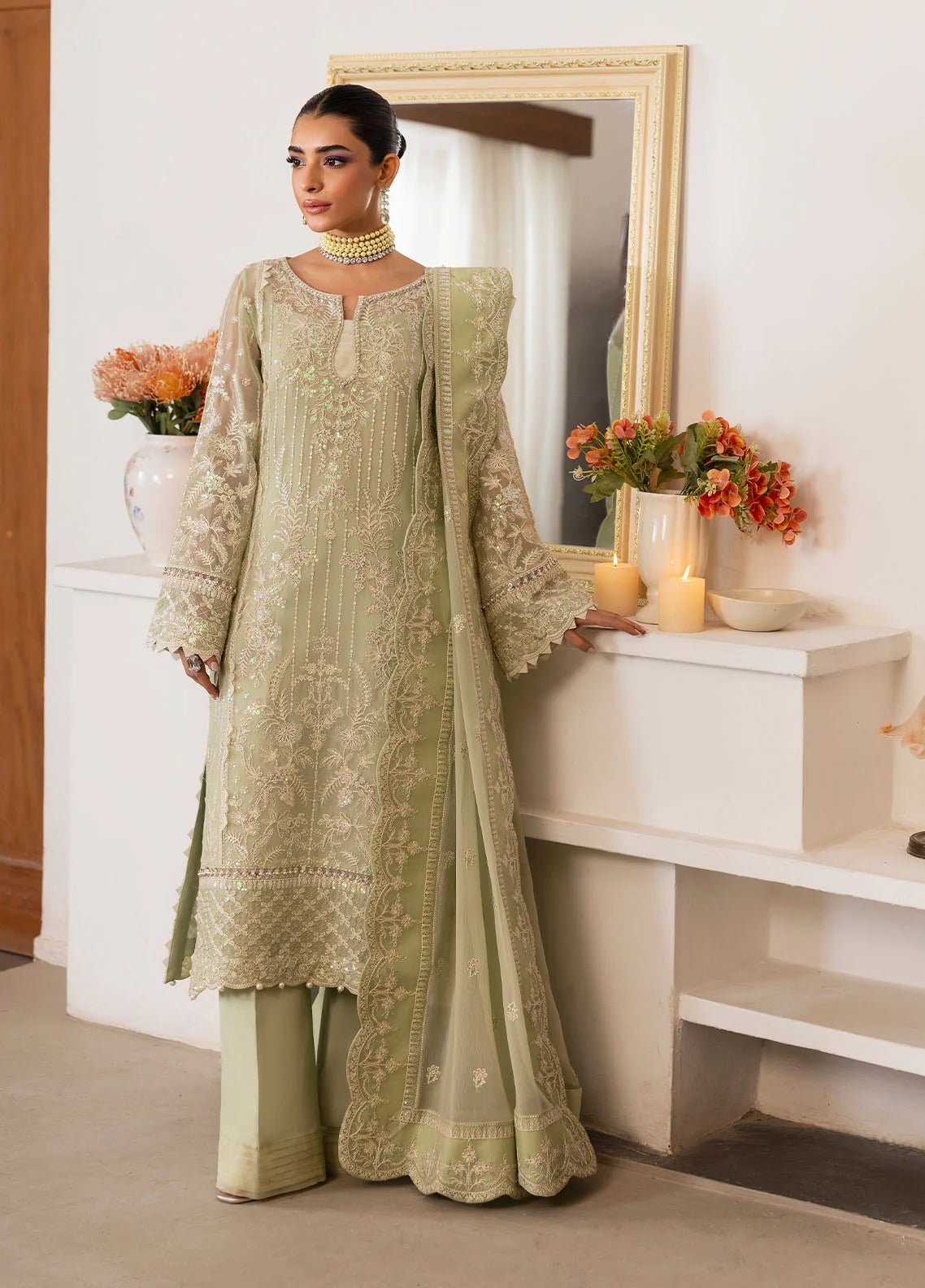 Model wearing Gulaal Virida pastel green embroidered chiffon dress with matching dupatta and trousers. Shop Pakistani clothes online in the UK now.