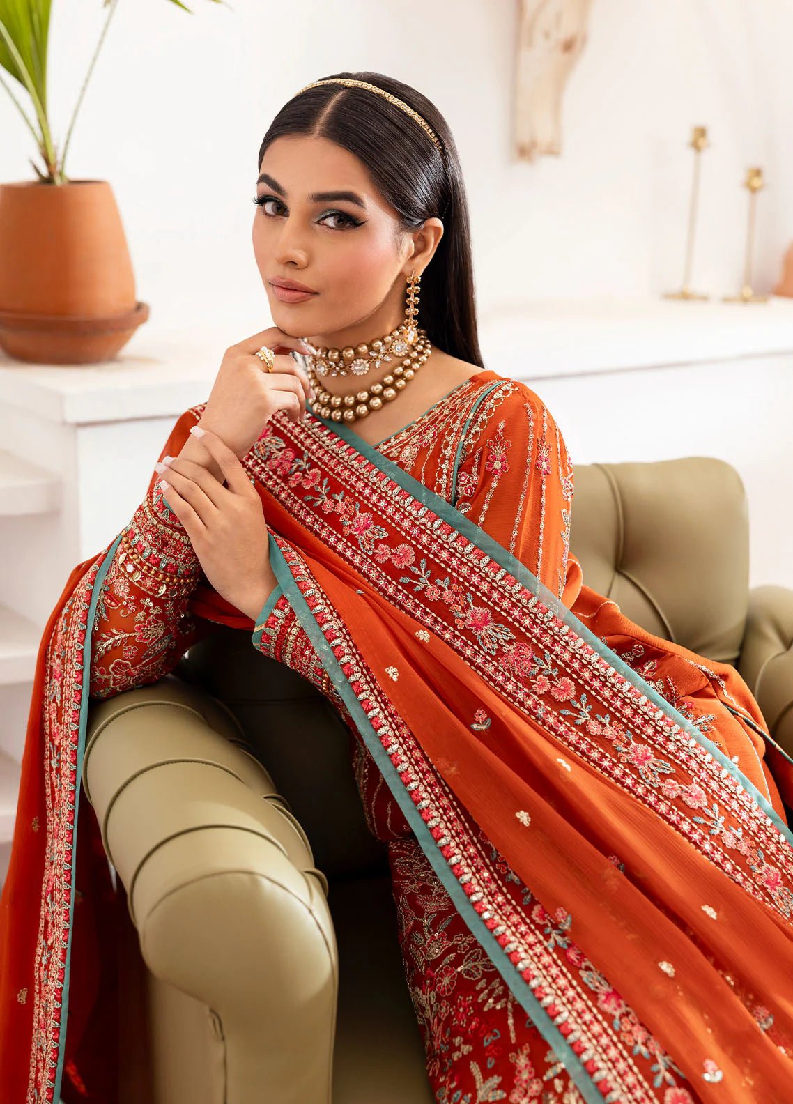 Model wearing Gulaal Zarna tiger lily embroidered chiffon dress with matching dupatta and trousers. Shop Pakistani clothes online in the UK now.