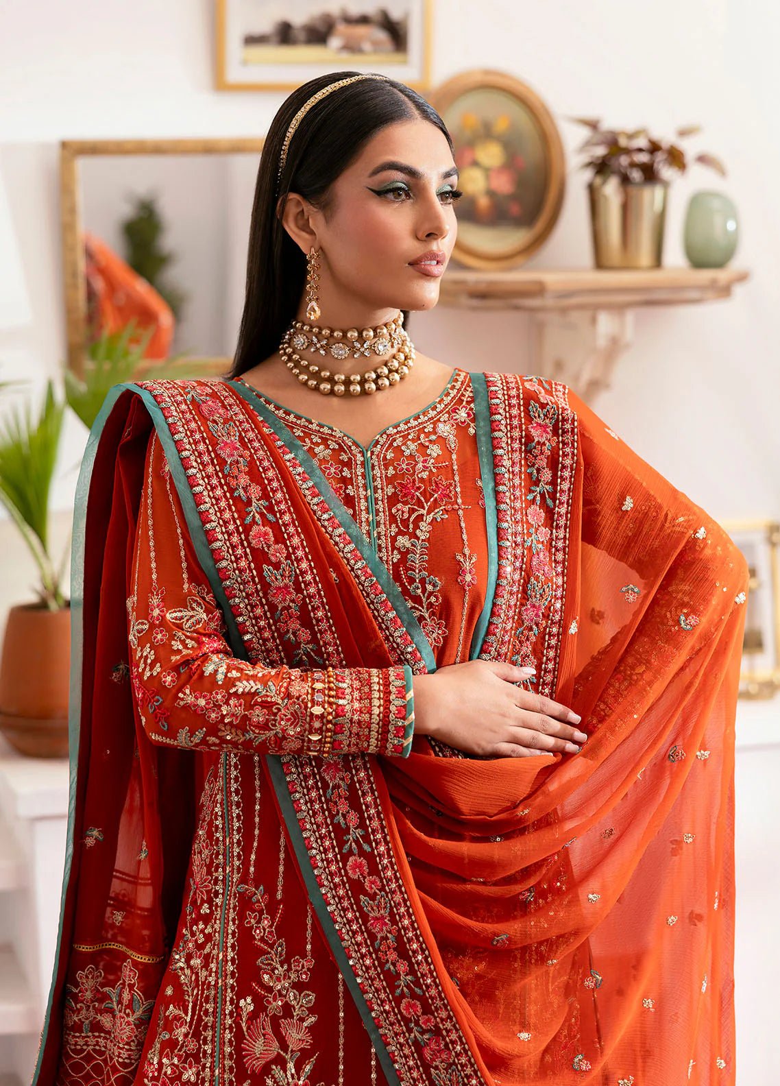 Model wearing Gulaal Zarna tiger lily embroidered chiffon dress with matching dupatta and trousers. Shop Pakistani clothes online in the UK now.