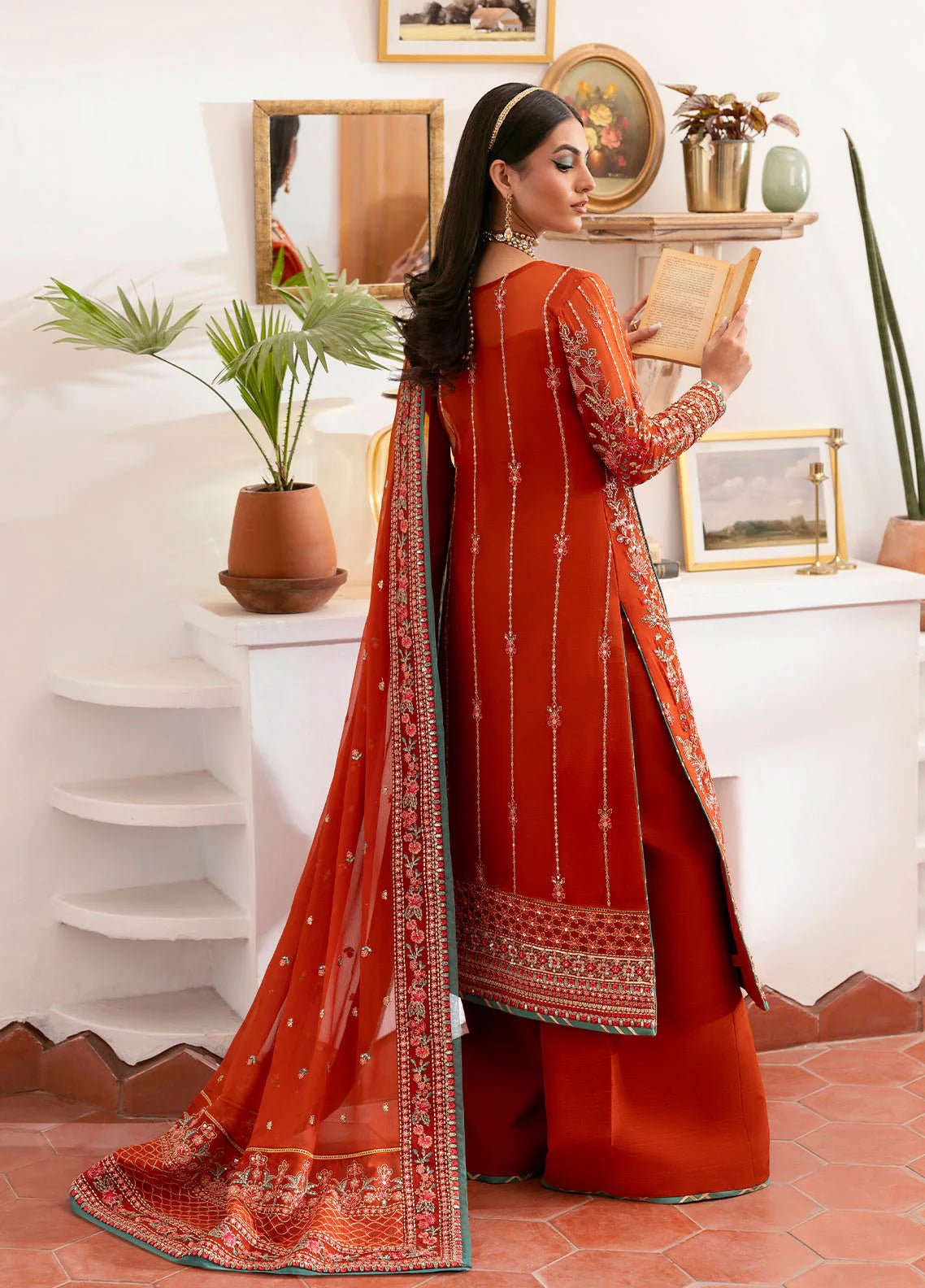 Model wearing Gulaal Zarna tiger lily embroidered chiffon dress with matching dupatta and trousers. Shop Pakistani clothes online in the UK now.