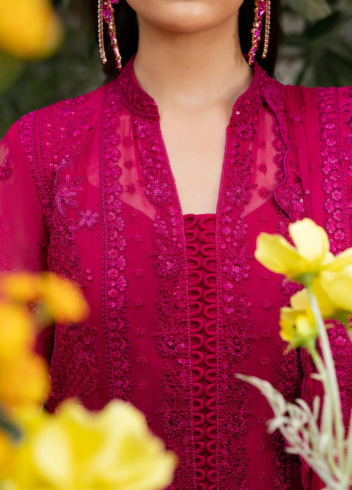 Model wearing Gulaal Zevira hot pink embroidered chiffon dress with matching dupatta and trousers. Shop Pakistani clothes online in the UK now.