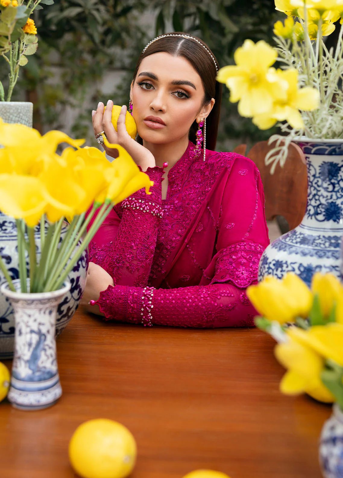 Model wearing Gulaal Zevira hot pink embroidered chiffon dress with matching dupatta and trousers. Shop Pakistani clothes online in the UK now.