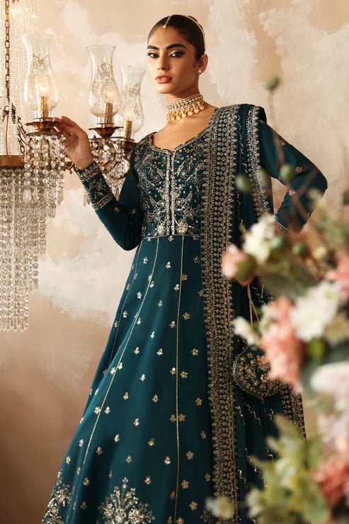 Model in a luxurious deep teal Gulaal Shehrnaaz Raw Silk kalidaar outfit featuring intricate embroidery and sequins, with an embroidered chiffon dupatta and organza borders, perfect for festive occasions.