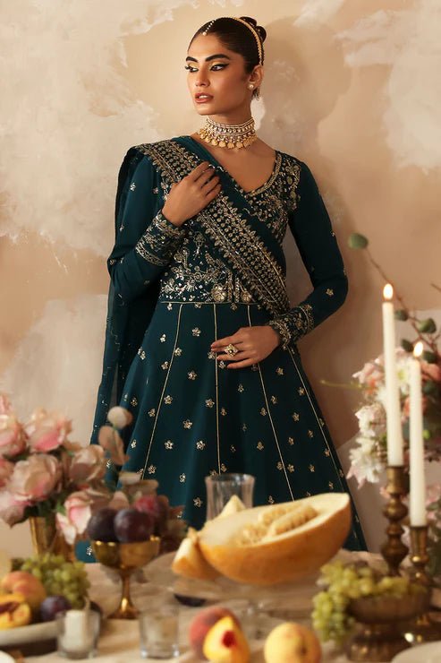 Model in a luxurious deep teal Gulaal Shehrnaaz Raw Silk kalidaar outfit featuring intricate embroidery and sequins, with an embroidered chiffon dupatta and organza borders, perfect for festive occasions.