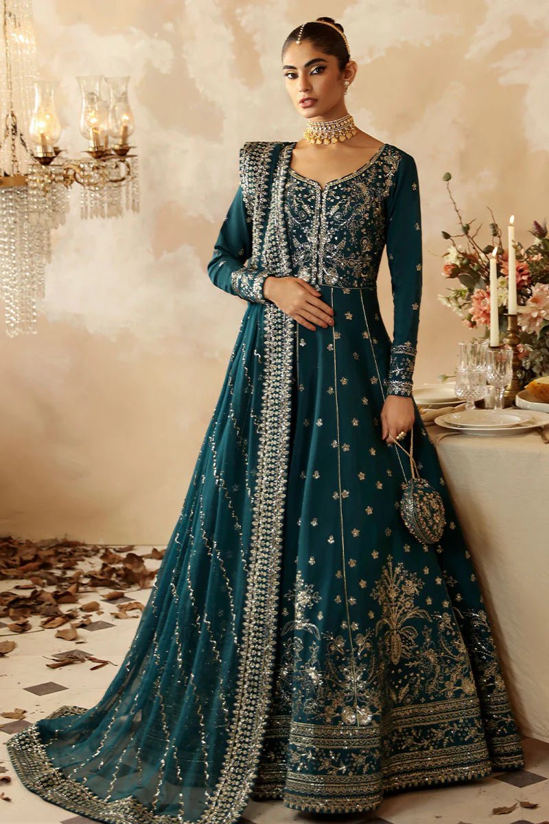 Model in a luxurious deep teal Gulaal Shehrnaaz Raw Silk kalidaar outfit featuring intricate embroidery and sequins, with an embroidered chiffon dupatta and organza borders, perfect for festive occasions.