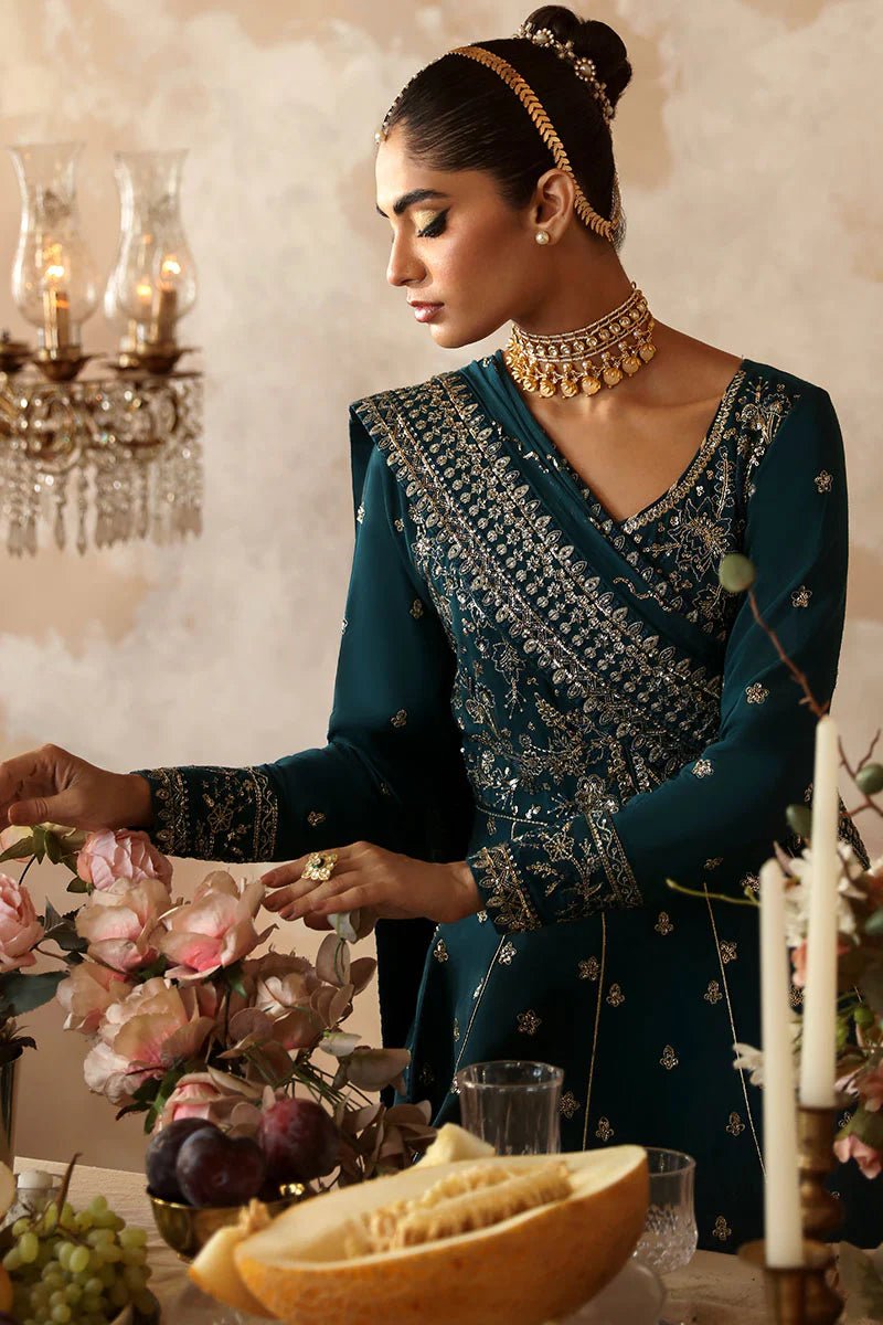 Model in a luxurious deep teal Gulaal Shehrnaaz Raw Silk kalidaar outfit featuring intricate embroidery and sequins, with an embroidered chiffon dupatta and organza borders, perfect for festive occasions.