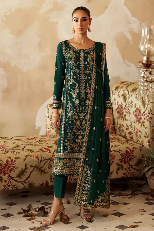 Model in a deep green Gulaal Shehrnaaz Raw Silk outfit with intricate embroidery and sequins, featuring a silk dupatta and matching trousers, perfect for festive occasions. Available online.