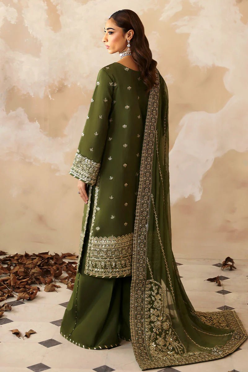 Model wearing an olive - green Gulaal Shehrnaaz Raw Silk outfit, embellished with intricate embroidery and sequins on the front, sleeves, and back. The look is completed with a fully embroidered chiffon dupatta and dyed silk trousers, ideal for festive occasions.