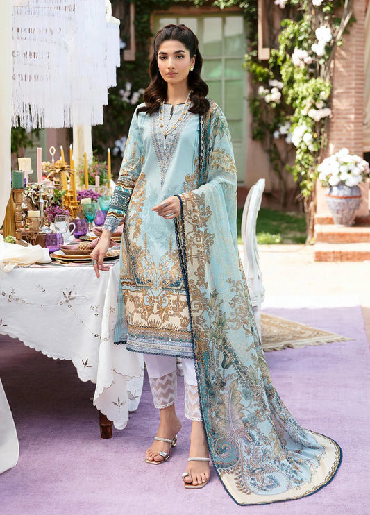 Model wearing Gulaal AMAYRAH dress, sky blue with golden embroidery, Pakistani designer lawn suit in UK.