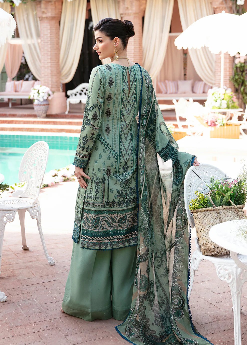 Model wearing the ANADIYA teal dress from Gulaal, elegantly highlighting Pakistani fashion online in the UK.