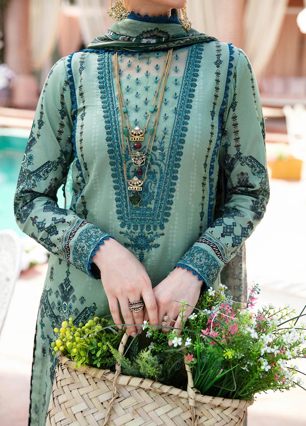 Model wearing the ANADIYA teal dress from Gulaal, elegantly highlighting Pakistani fashion online in the UK.