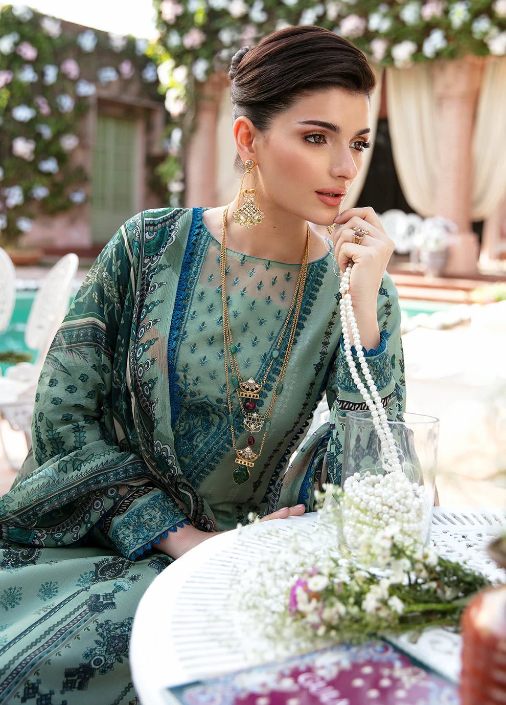 Model wearing the ANADIYA teal dress from Gulaal, elegantly highlighting Pakistani fashion online in the UK.