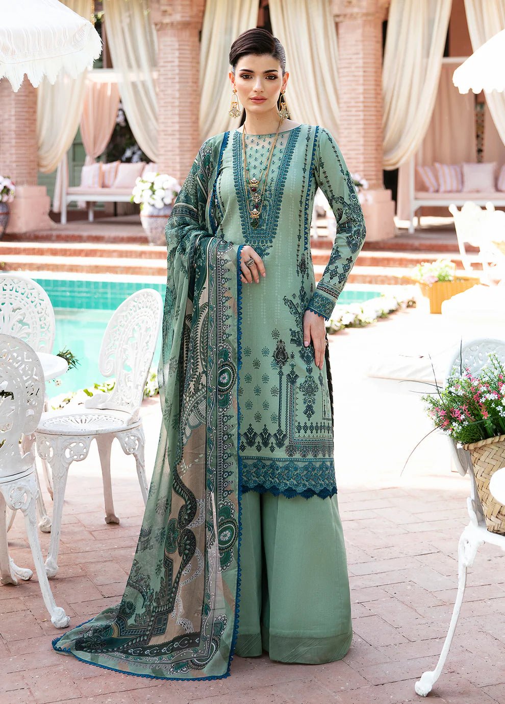 Model wearing Gulaal ANDREA dress, teal with intricate embroidery, Pakistani designer lawn suit in UK.