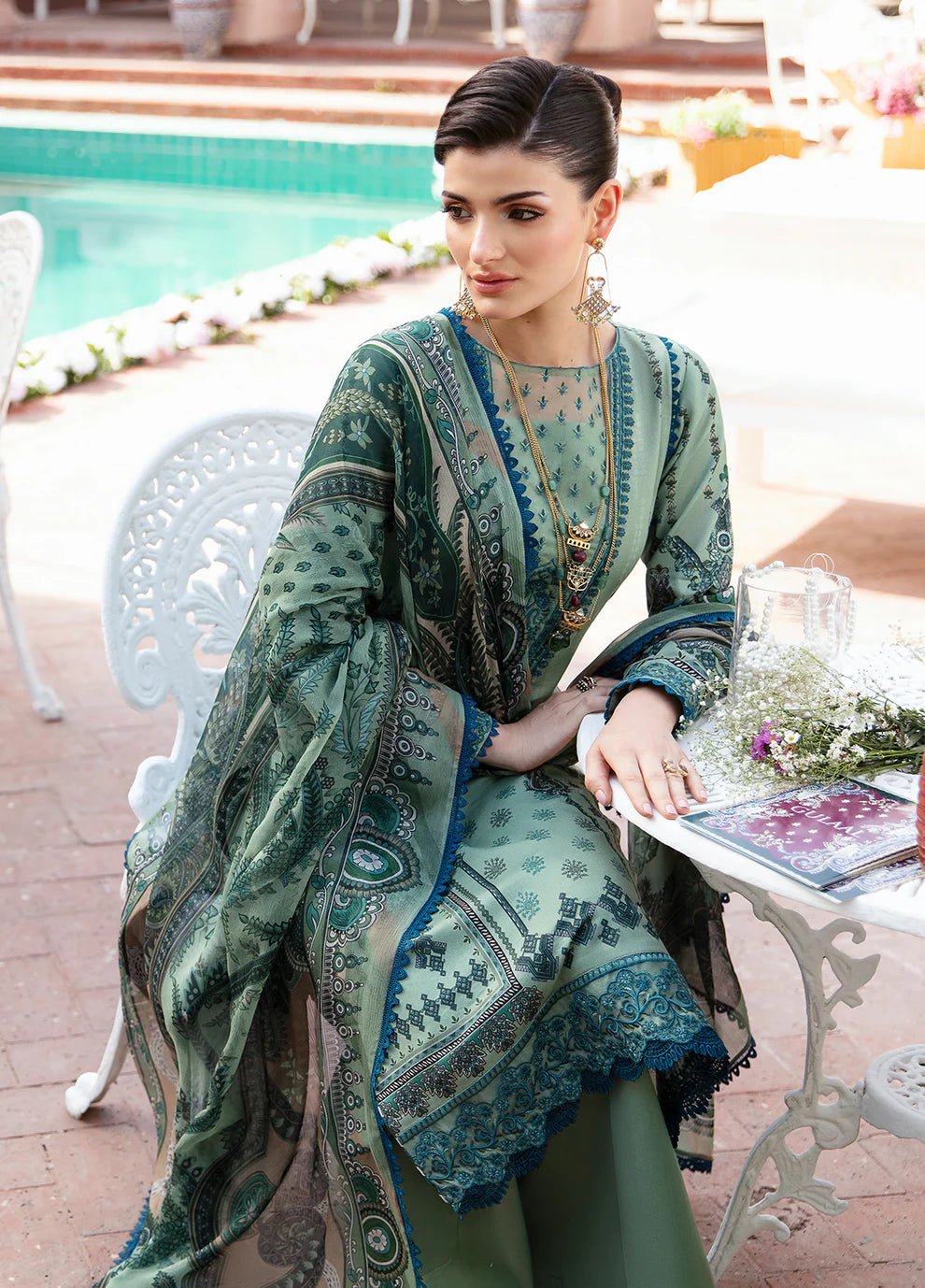 Model wearing the ANADIYA teal dress from Gulaal, elegantly highlighting Pakistani fashion online in the UK.