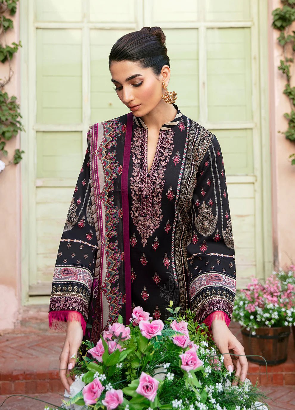 Model wearing the ANDREA black floral dress from Gulaal, showcasing elegant Pakistani fashion online in the UK.