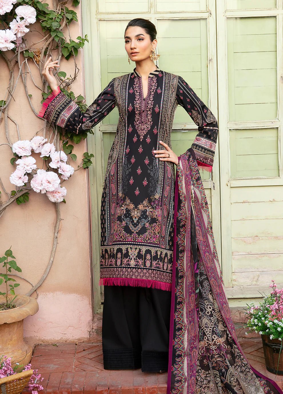 Model wearing Gulaal ANDREA dress, black with vibrant embroidery, Pakistani lawn suit in UK.