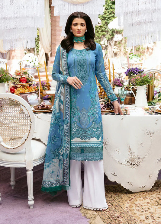 Model wearing Gulaal ELAINE dress, cerulean blue with detailed embroidery, Pakistani designer lawn suit in UK.