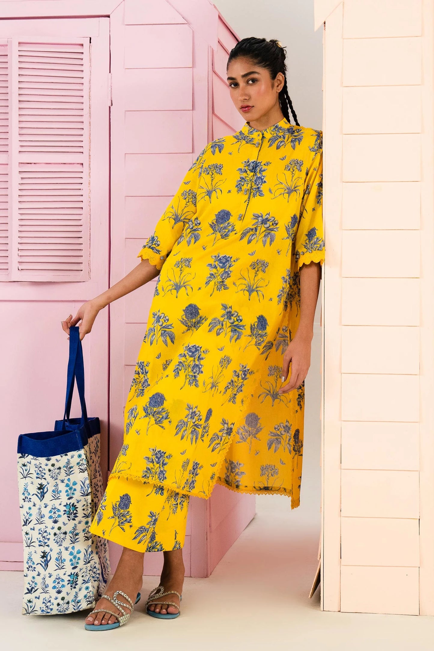 Model wearing Sana Safinaz Mahay'24 yellow lawn dress with floral print, Pakistani summer attire, available in UK.