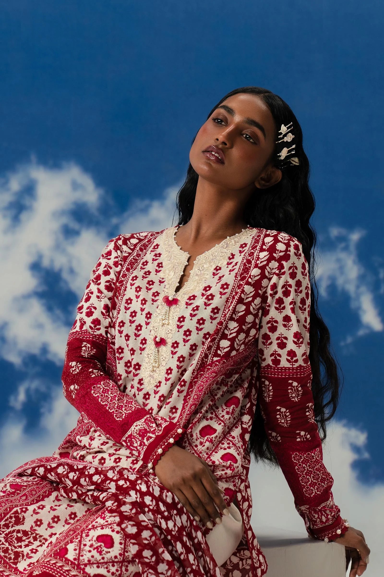 Model wearing Sana Safinaz Mahay'24 red patterned lawn suit, designer summer dress from Pakistan in UK.