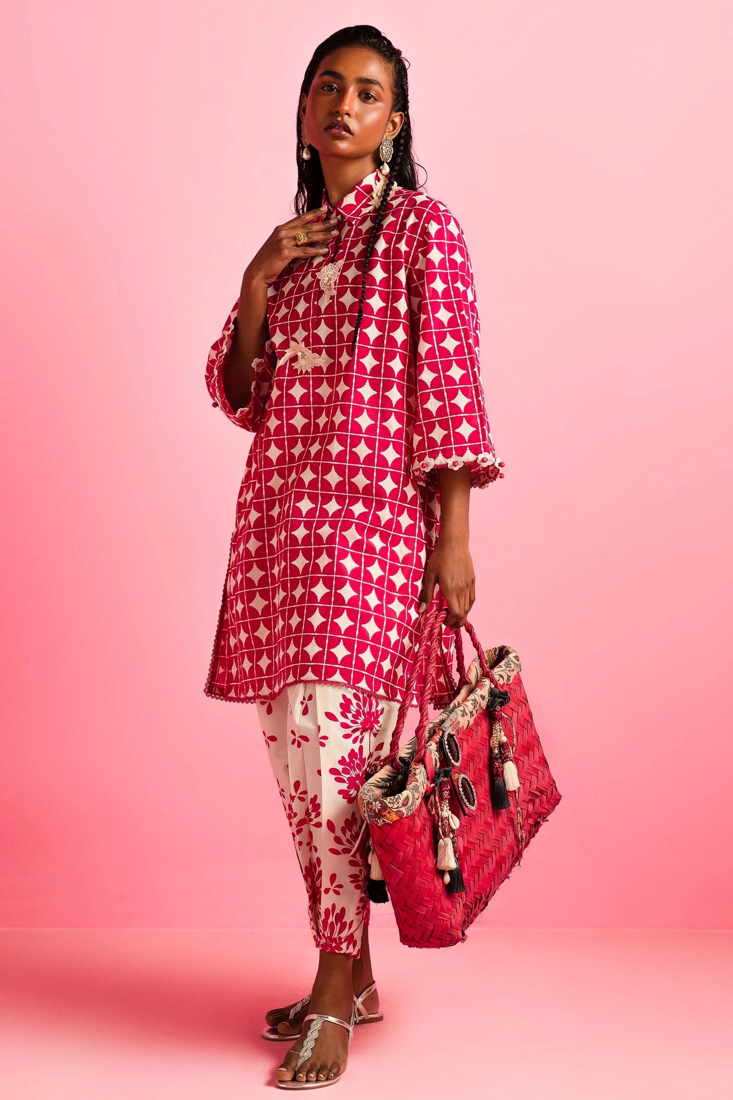 Model wearing Sana Safinaz Mahay'24 red geometric lawn dress, vibrant summer style in UK.