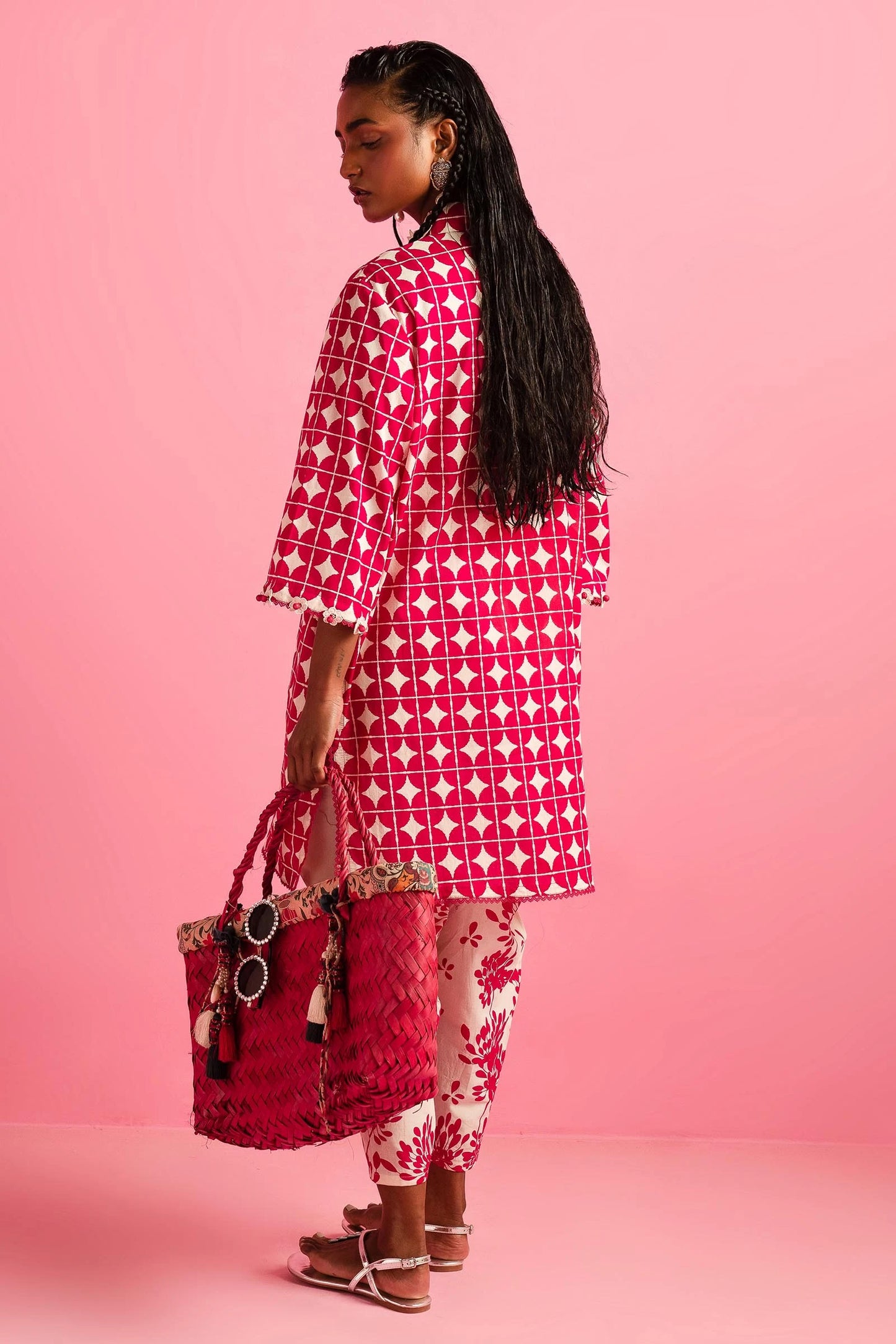 Model wearing Sana Safinaz Mahay'24 red geometric lawn dress, vibrant summer style in UK.