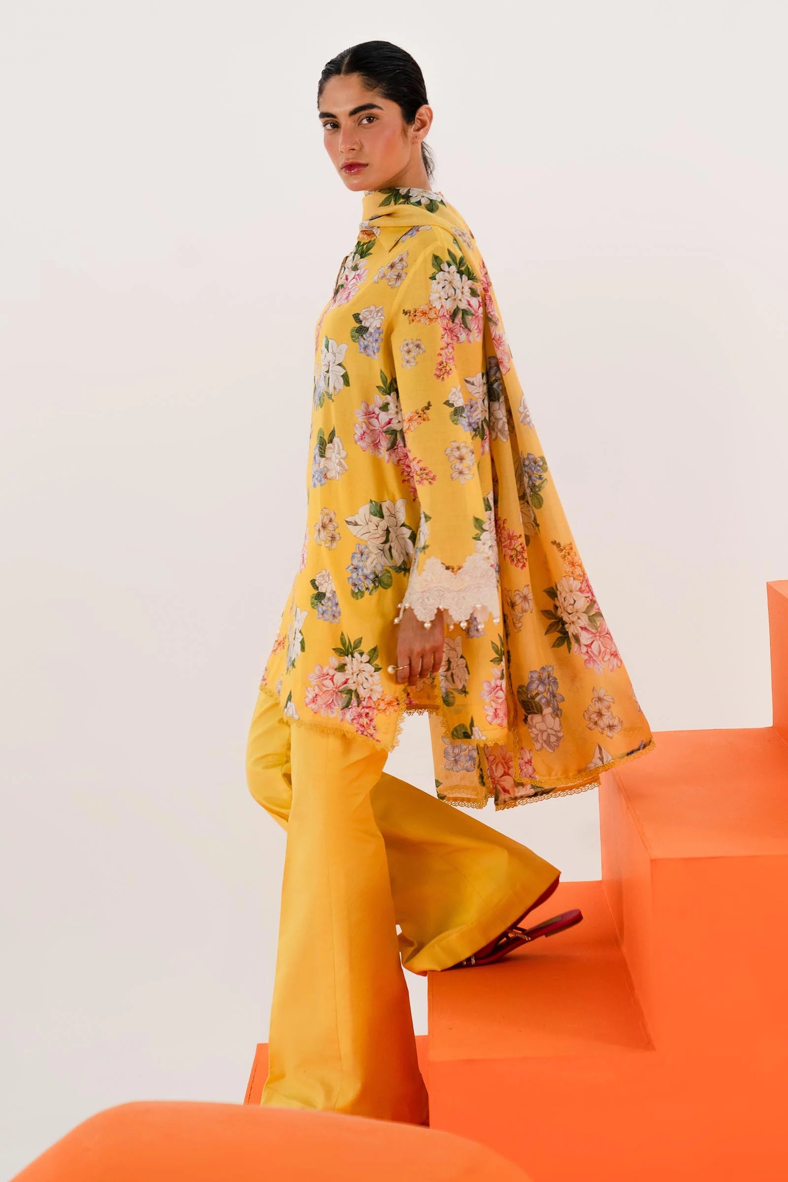 Model wearing Sana Safinaz Mahay'24 yellow floral lawn suit, bright summer outfit in UK.