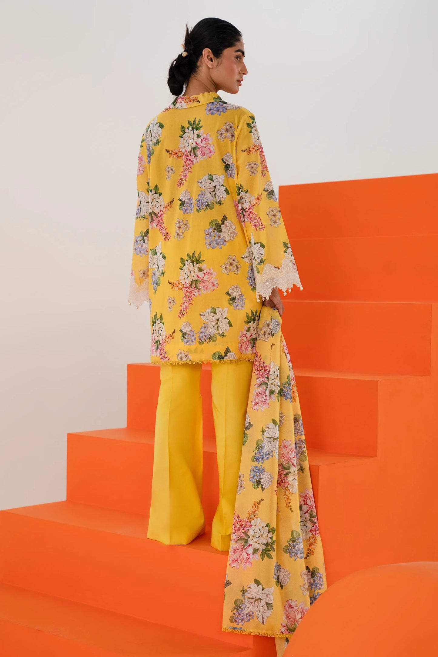 Model wearing Sana Safinaz Mahay'24 yellow floral lawn suit, bright summer outfit in UK.