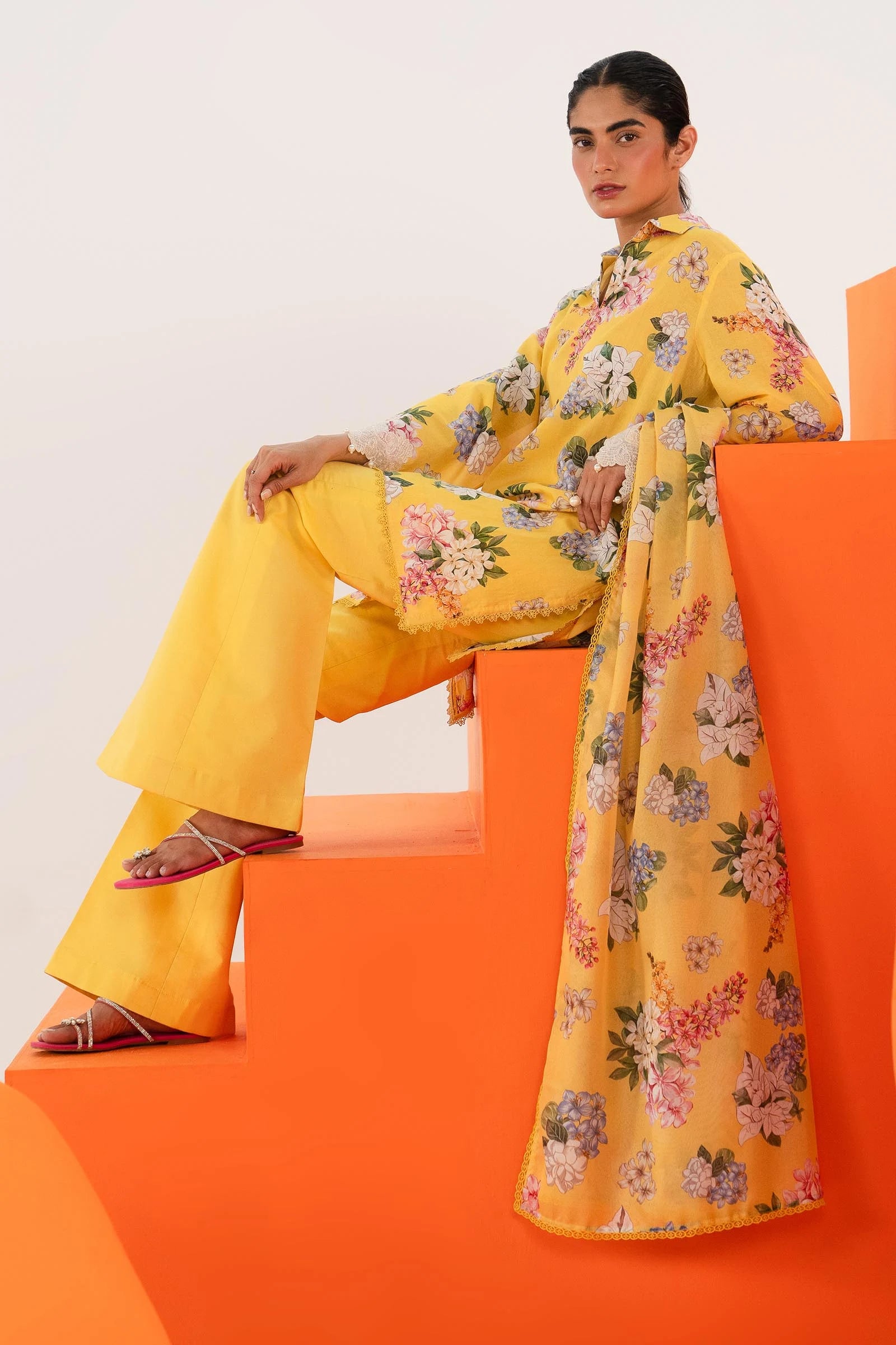 Model wearing Sana Safinaz Mahay'24 yellow floral lawn suit, bright summer outfit in UK.