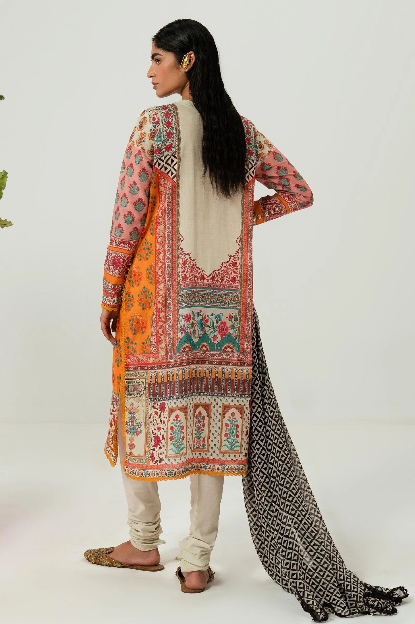 Model wearing Sana Safinaz H242 - 013B - 2I orange Pakistani lawn suit with black and white dupatta.