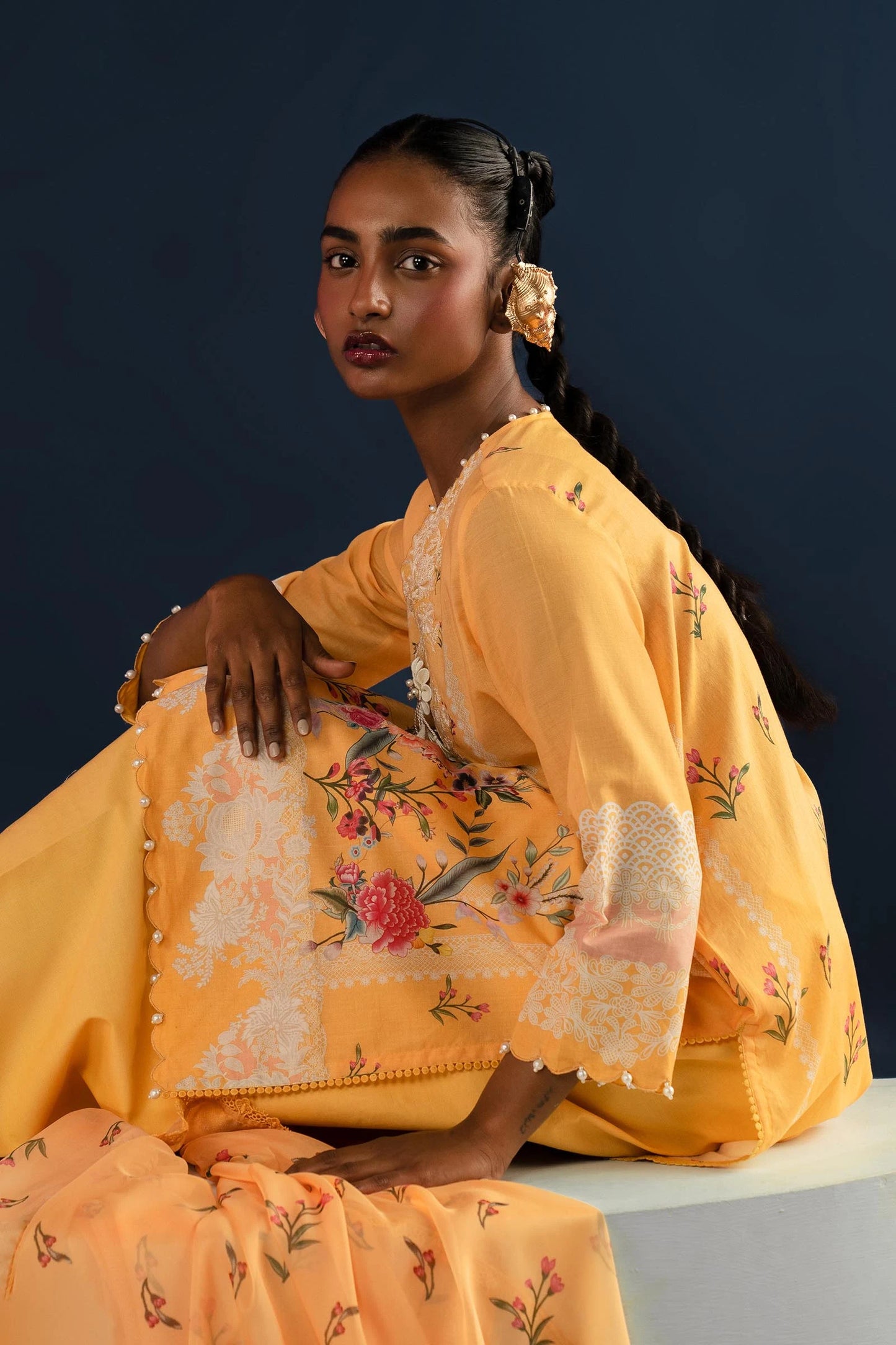 Model wearing yellow embroidered Pakistani lawn clothing for summer.