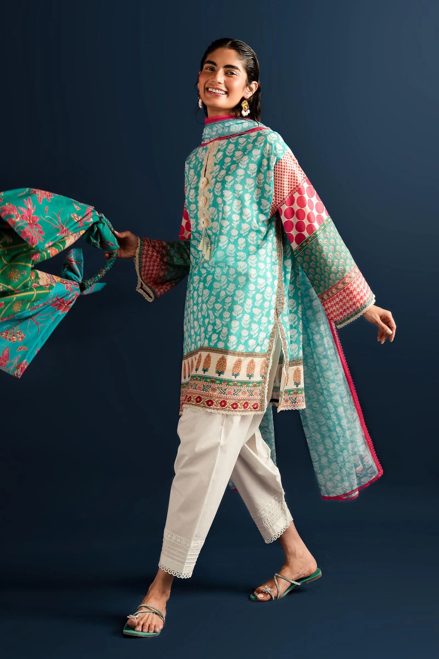 Model wearing Sana Safinaz turquoise and pink lawn dress, Pakistani summer fashion in the UK.