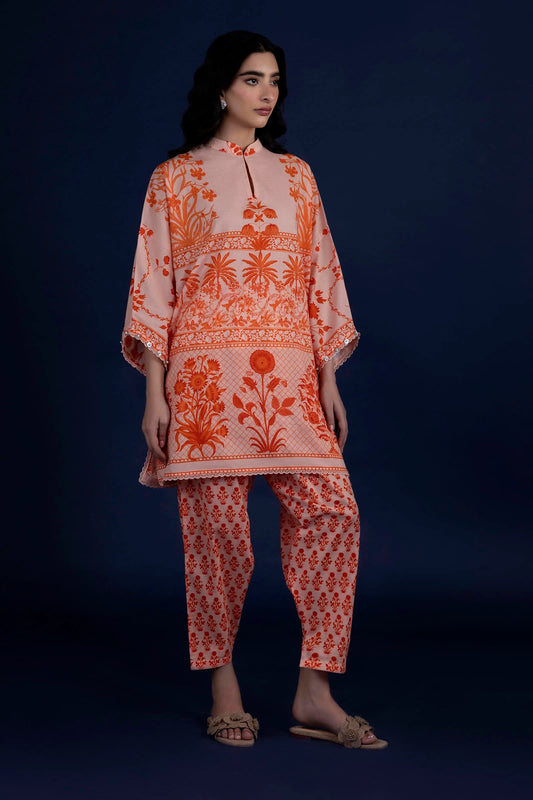 Model wearing peach and orange printed outfit from Sana Safinaz, Mahay Spring '25, ideal for Pakistani clothes online in UK and luxury pret.
