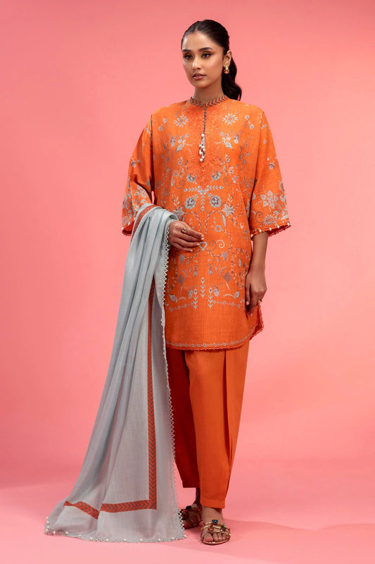 Model wearing bright orange embroidered outfit with light grey dupatta from Sana Safinaz, Mahay Spring '25, Pakistani casual pret in UK.
